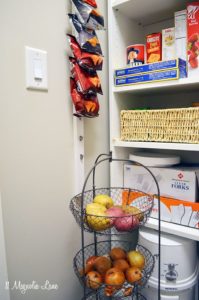 Kitchen pantry organization ideas include hanging clips on a wall.