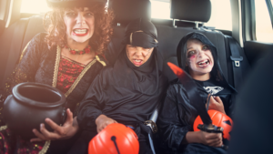 Consider going site-seeing this Halloween if the kids can't go trick-or-treating during the coronavirus pandemic. This image shows three children in the back seat of a vehicle in their Halloween costumes.