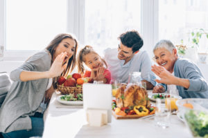 A family celebrates a virtual Thanksgiving.