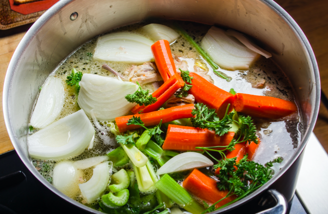 A closeup, overhead view of a pot of vegetable soup